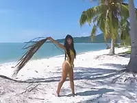 Micro bikini tease by sexy teen who walks on a beach